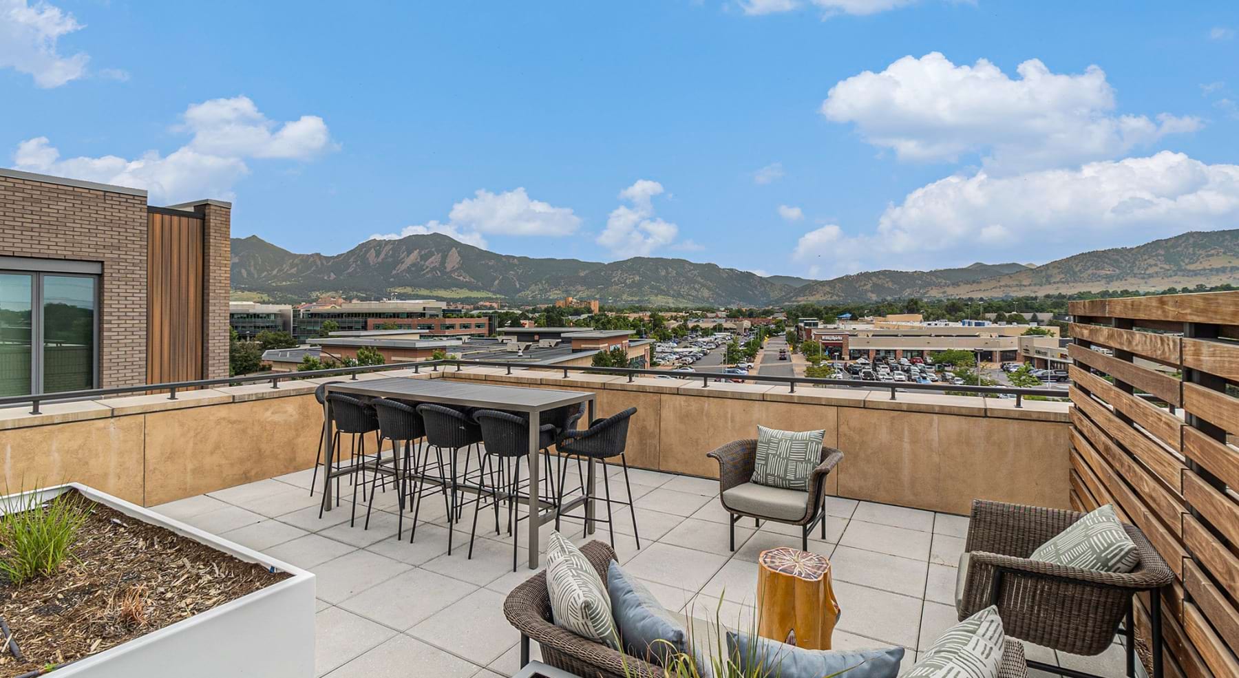 a rooftop lounge area overlooking mountains