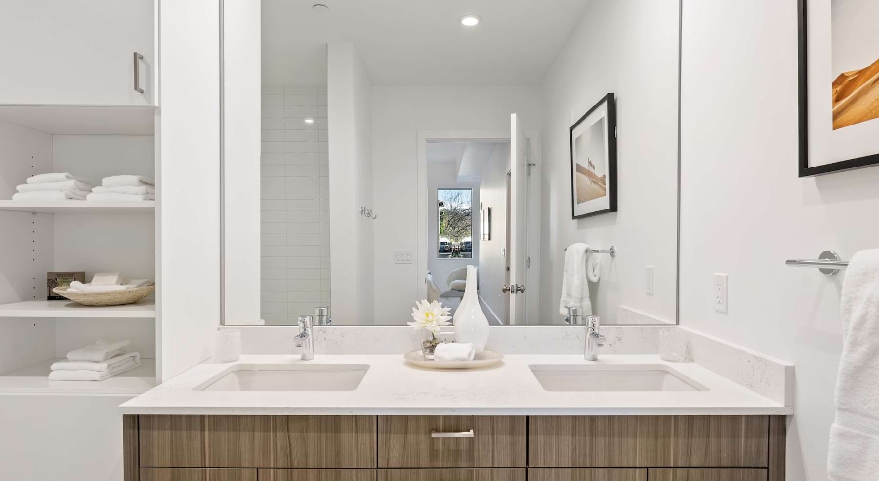 a spacious bathroom with a large mirror and ample light