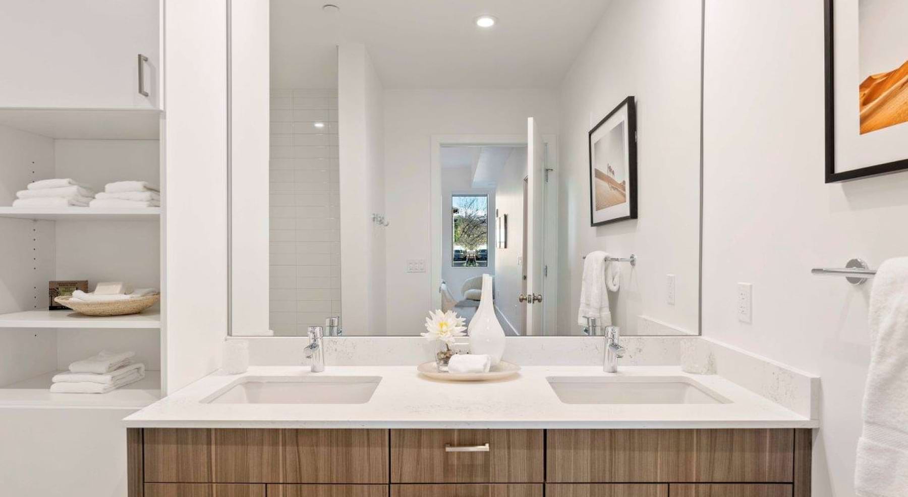 a spacious bathroom with a large mirror and ample light