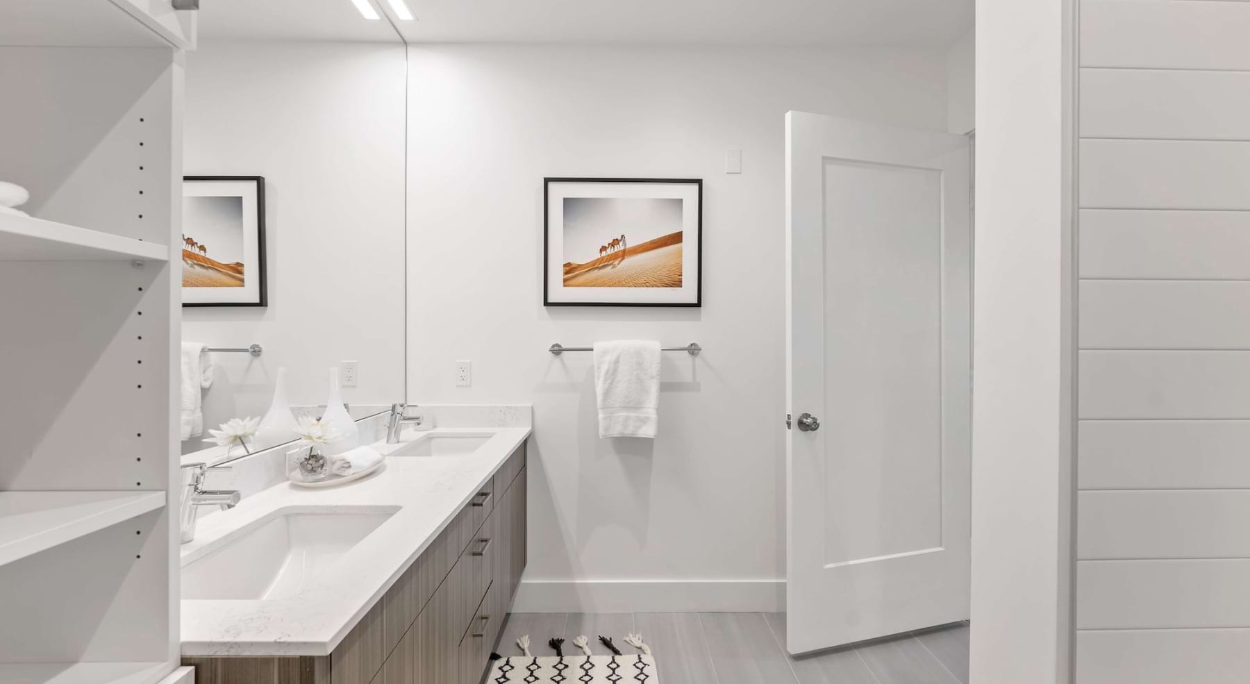a spacious bathroom with a large mirror and ample light