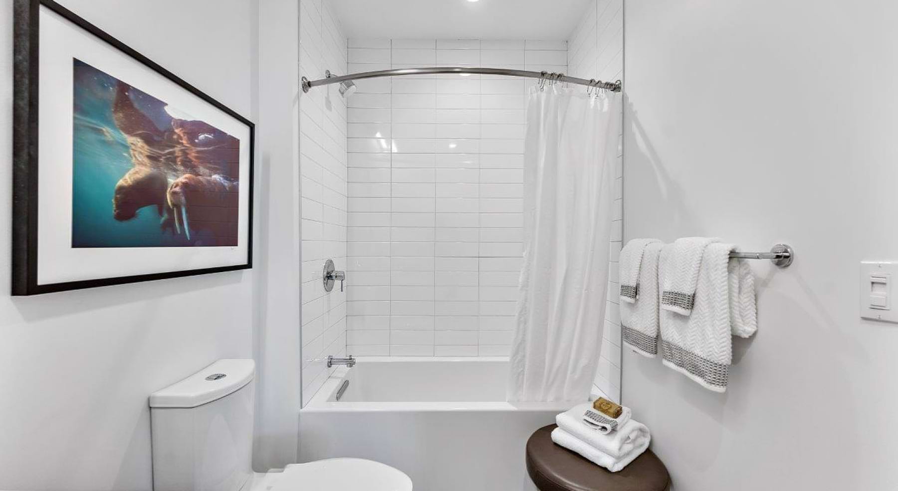 a spacious bathroom with a large mirror and ample light