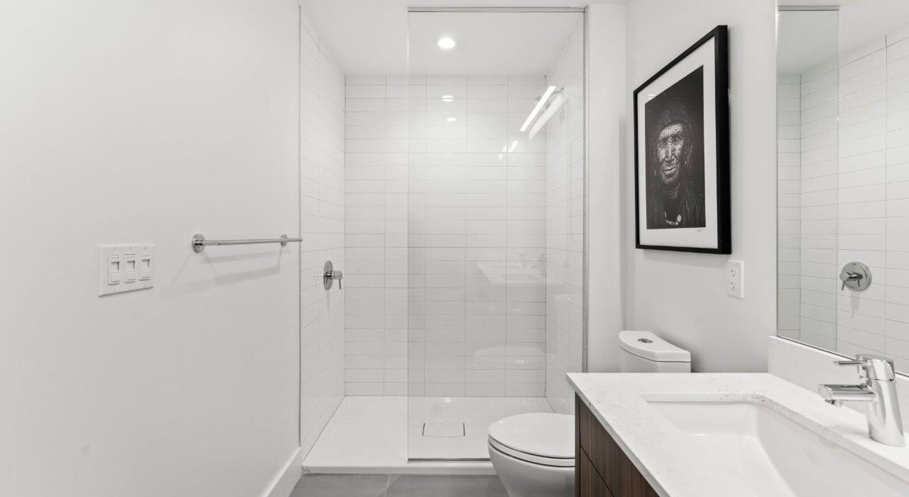 a spacious bathroom with a large mirror and ample light